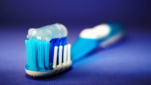 blue toothbrush with toothpaste