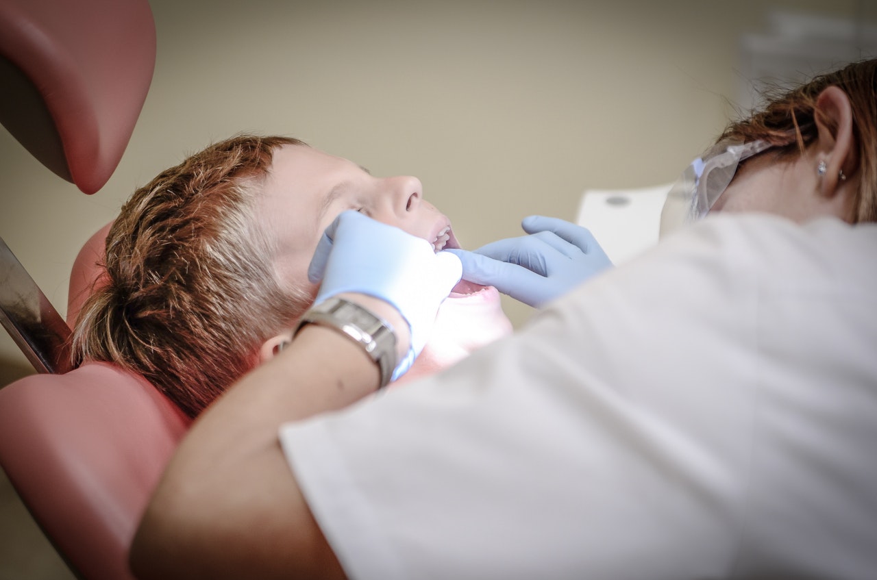 a dentist examining patient